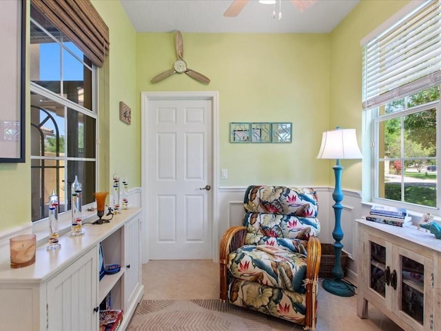 2724 Palm Tree Dr, Poinciana, FL 34759 - sitting room featuring a wainscoted wall and ceiling fan