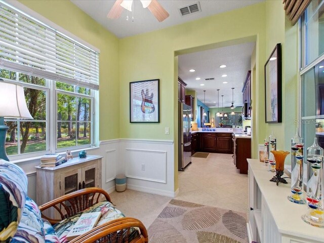 2724 Palm Tree Dr, Poinciana, FL 34759 - living area featuring wainscoting, visible vents, recessed lighting, ceiling fan, and light tile patterned floors