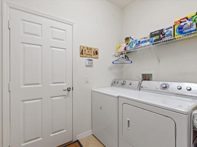 2724 Palm Tree Dr, Poinciana, FL 34759 - clothes washing area featuring washing machine and dryer, laundry area, and baseboards