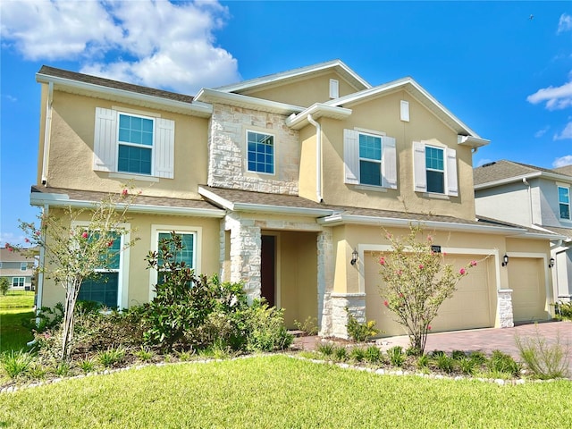 5019 Down Ct, Saint Cloud, FL 34772 - view of front facade featuring driveway, stucco siding, stone siding, and an attached garage