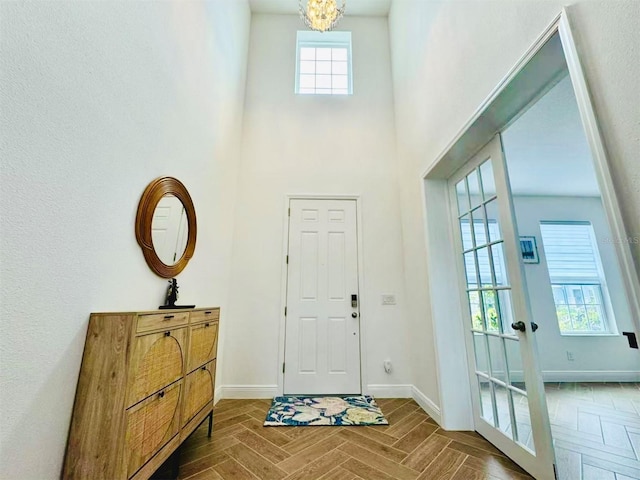 5019 Down Ct, Saint Cloud, FL 34772 - entrance foyer featuring an inviting chandelier, baseboards, and a towering ceiling