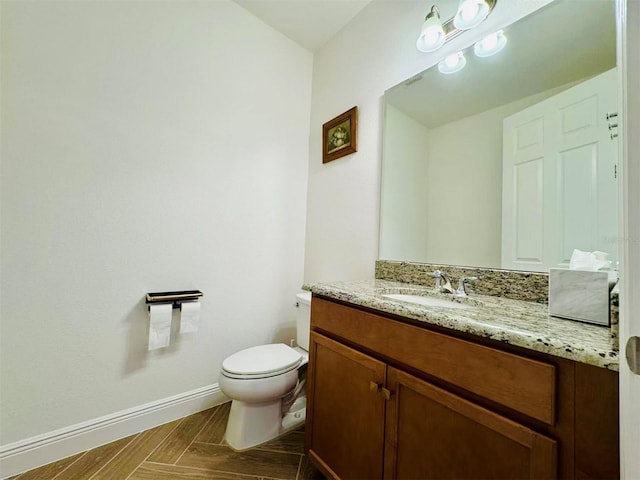 5019 Down Ct, Saint Cloud, FL 34772 - half bathroom featuring toilet, baseboards, and vanity