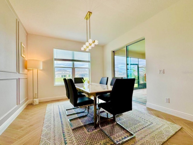 5019 Down Ct, Saint Cloud, FL 34772 - dining room featuring light wood-style flooring, an inviting chandelier, and baseboards