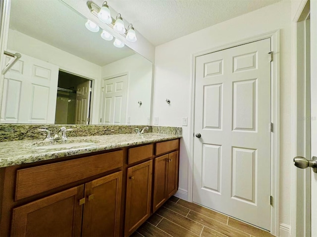 5019 Down Ct, Saint Cloud, FL 34772 - full bathroom featuring a sink, a shower with shower door, double vanity, baseboards, and wood tiled floor