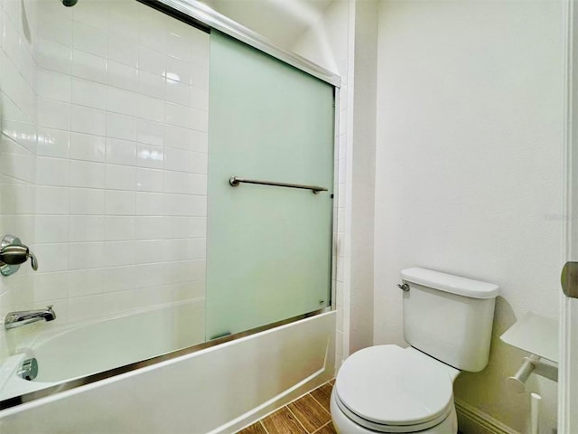 5019 Down Ct, Saint Cloud, FL 34772 - full bathroom featuring wood finished floors, enclosed tub / shower combo, and toilet
