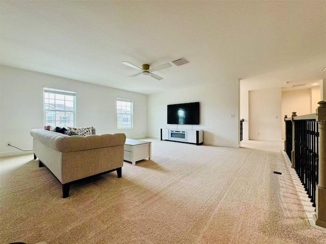 5019 Down Ct, Saint Cloud, FL 34772 - living area featuring light colored carpet, ceiling fan, baseboards, and visible vents