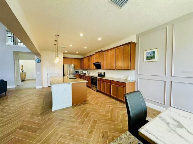 5019 Down Ct, Saint Cloud, FL 34772 - kitchen with brown cabinetry, a kitchen island with sink, stainless steel appliances, exhaust hood, and visible vents
