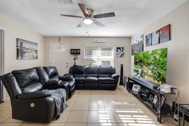 living area with tile patterned floors and a ceiling fan