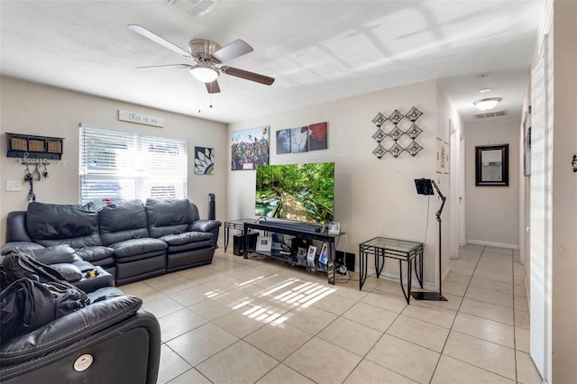 living area featuring visible vents, a ceiling fan, and light tile patterned flooring