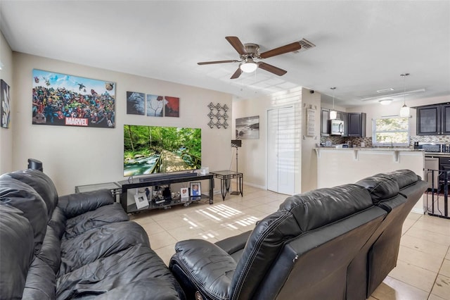 living room with light tile patterned flooring and ceiling fan