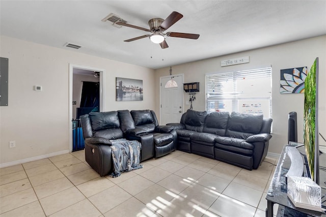 living area featuring visible vents, light tile patterned floors, ceiling fan, and baseboards