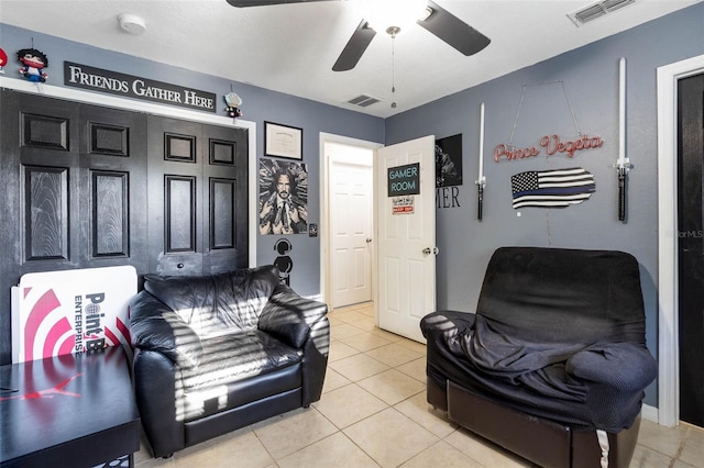 living room featuring visible vents, tile patterned floors, and a ceiling fan