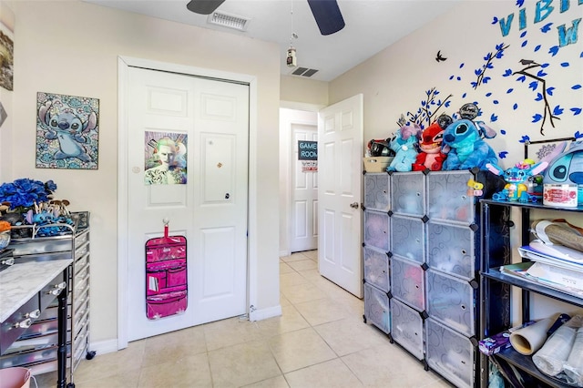 storage with a ceiling fan and visible vents
