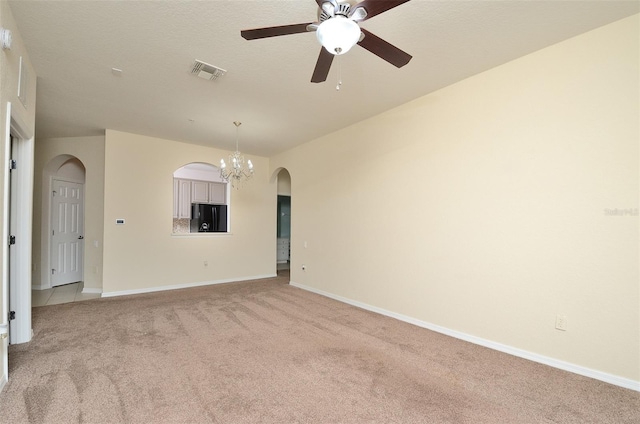 1357 Venezia Ct Unit 202, Davenport, FL 33896 - spare room with arched walkways, light carpet, a chandelier, ceiling fan, and baseboards