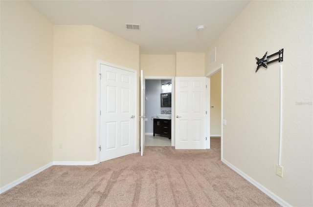 1357 Venezia Ct Unit 202, Davenport, FL 33896 - unfurnished bedroom with light colored carpet, baseboards, and visible vents