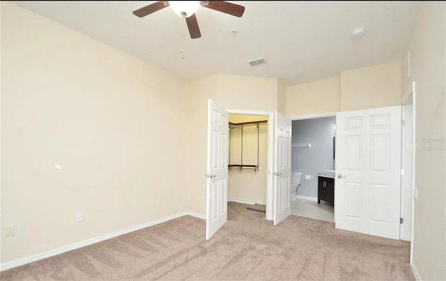 1357 Venezia Ct Unit 202, Davenport, FL 33896 - unfurnished bedroom featuring light carpet, baseboards, a ceiling fan, and a closet