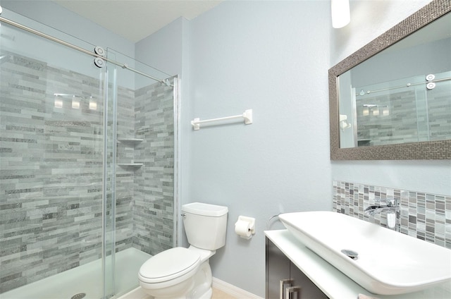 1357 Venezia Ct Unit 202, Davenport, FL 33896 - bathroom featuring baseboards, toilet, a shower stall, vanity, and tasteful backsplash