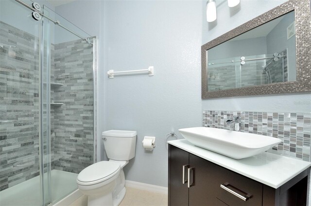 1357 Venezia Ct Unit 202, Davenport, FL 33896 - full bathroom featuring a stall shower, vanity, toilet, and decorative backsplash