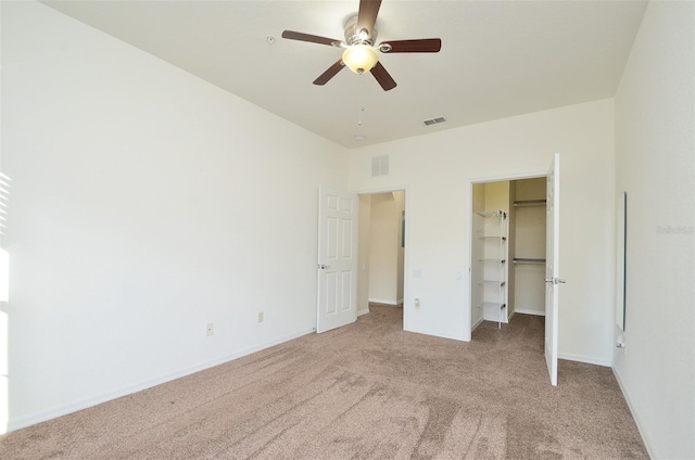 1357 Venezia Ct Unit 202, Davenport, FL 33896 - unfurnished bedroom with carpet flooring, a walk in closet, baseboards, and a closet