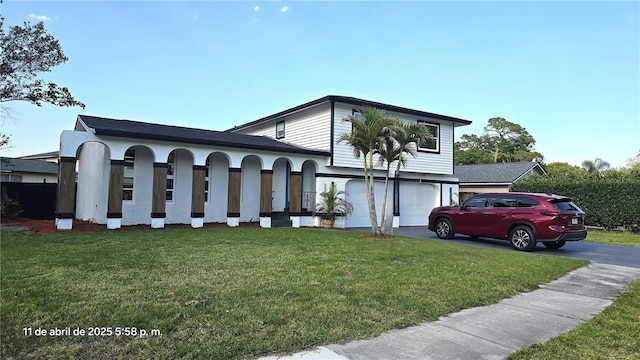 view of front of home featuring stucco siding, a front lawn, aphalt driveway, and a garage