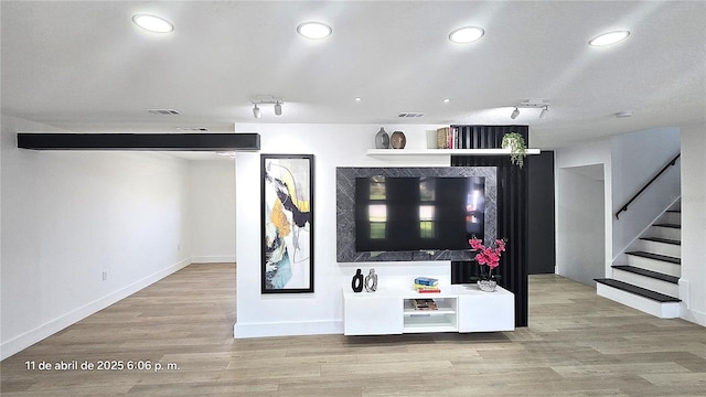 unfurnished living room featuring visible vents, wood finished floors, and recessed lighting