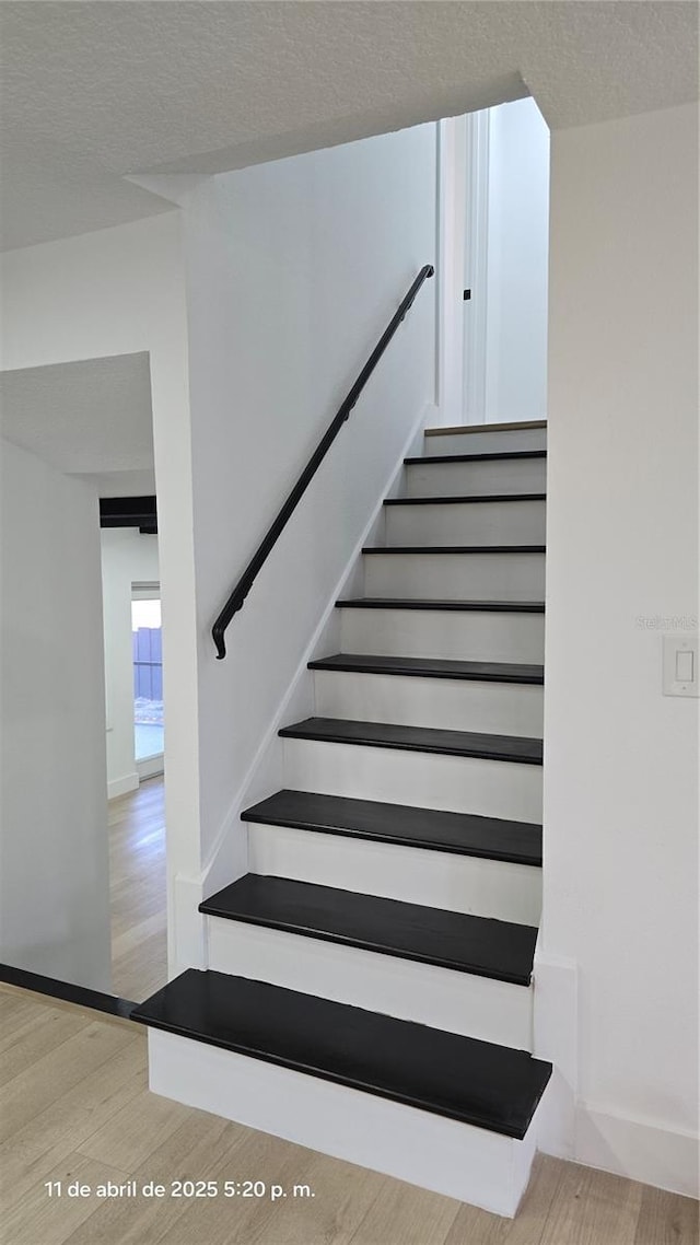 stairs with baseboards and wood finished floors