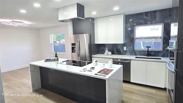 kitchen featuring white cabinets, modern cabinets, appliances with stainless steel finishes, and a sink