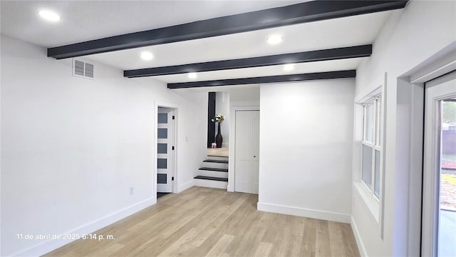 unfurnished bedroom featuring beamed ceiling, light wood-style flooring, baseboards, and recessed lighting