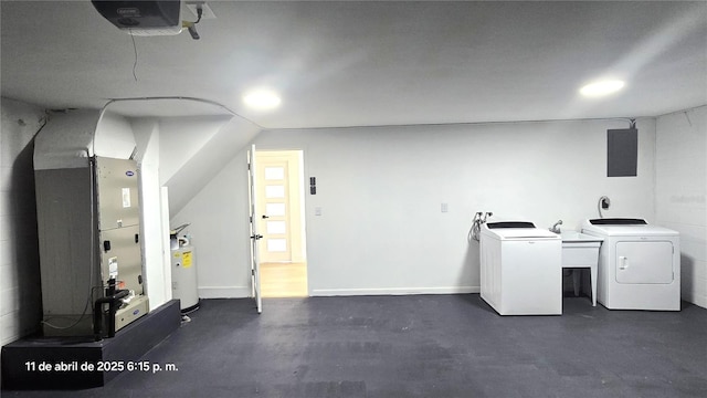 interior space with electric panel, heating unit, a sink, and independent washer and dryer