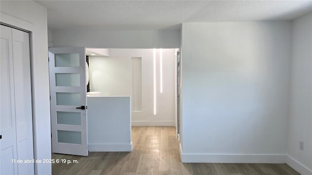 empty room featuring baseboards and wood finished floors