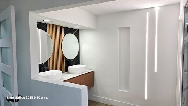 full bath with wood finished floors, a sink, and double vanity