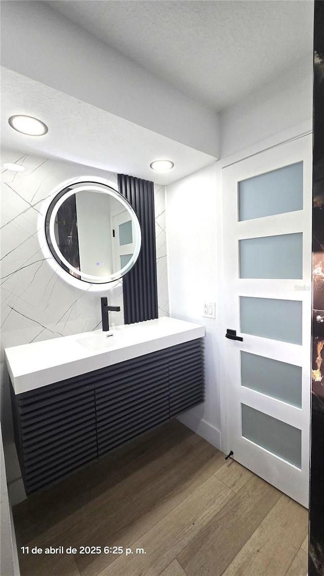 bathroom featuring wood finished floors and vanity