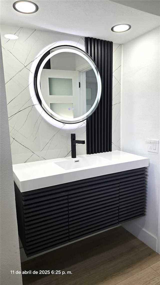 interior details with vanity and wood finished floors