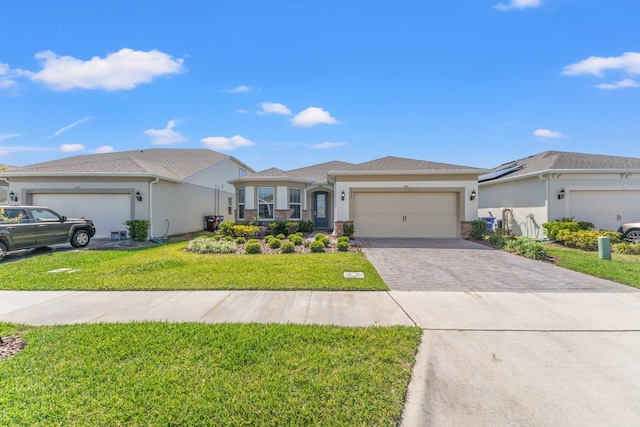 2019 Spring Shower Cir, Kissimmee, FL 34744 - view of front of home with stucco siding, a front lawn, driveway, and a garage