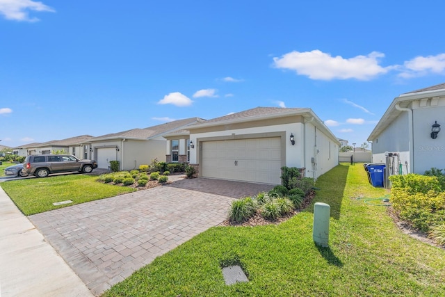 2019 Spring Shower Cir, Kissimmee, FL 34744 - view of front of property featuring stucco siding, an attached garage, a front yard, and decorative driveway