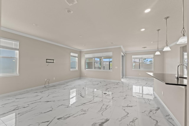 2019 Spring Shower Cir, Kissimmee, FL 34744 - unfurnished living room with a sink, a healthy amount of sunlight, baseboards, recessed lighting, and ornamental molding