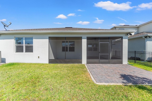 2019 Spring Shower Cir, Kissimmee, FL 34744 - back of property featuring fence, a yard, a sunroom, a patio, and stucco siding