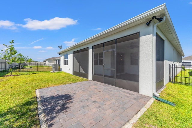 2019 Spring Shower Cir, Kissimmee, FL 34744 - rear view of property featuring fence, a lawn, a sunroom, and a patio area