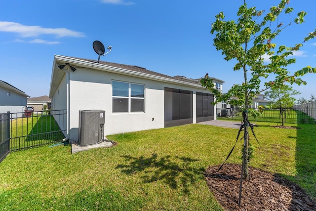 2019 Spring Shower Cir, Kissimmee, FL 34744 - rear view of house featuring central air condition unit, a lawn, and stucco siding