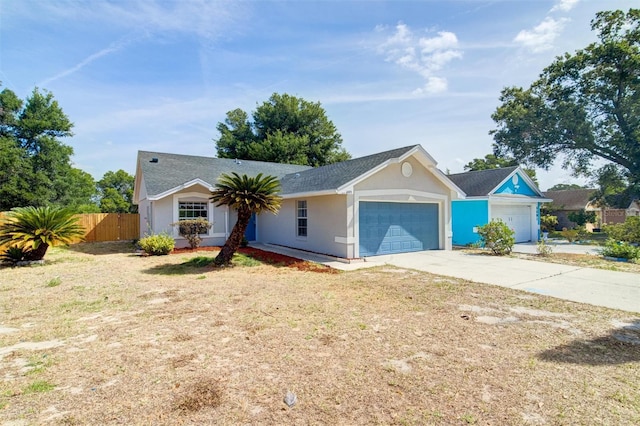ranch-style house with fence, a shingled roof, concrete driveway, stucco siding, and a garage