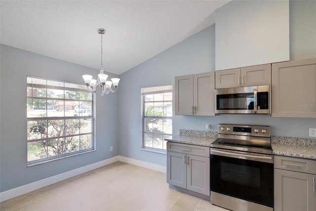kitchen with vaulted ceiling, a chandelier, baseboards, appliances with stainless steel finishes, and gray cabinetry