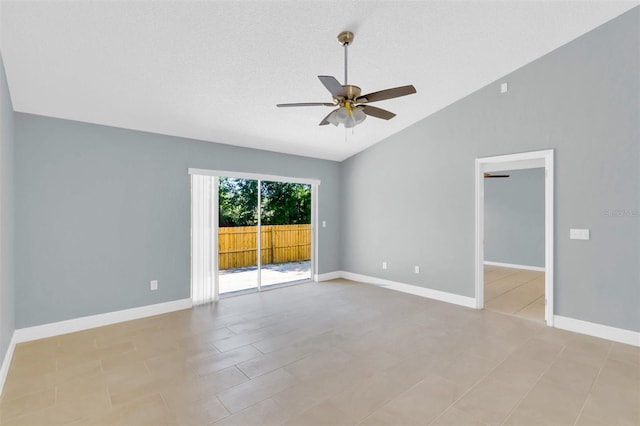 empty room featuring lofted ceiling, baseboards, and ceiling fan