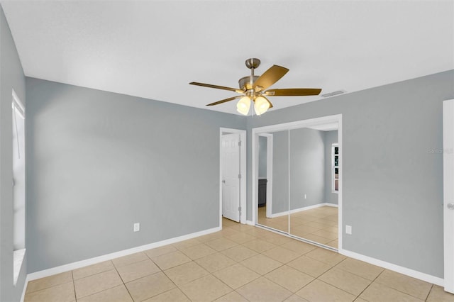 unfurnished room with visible vents, baseboards, ceiling fan, and light tile patterned floors