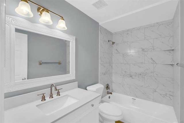 bathroom featuring visible vents, vanity, washtub / shower combination, and toilet