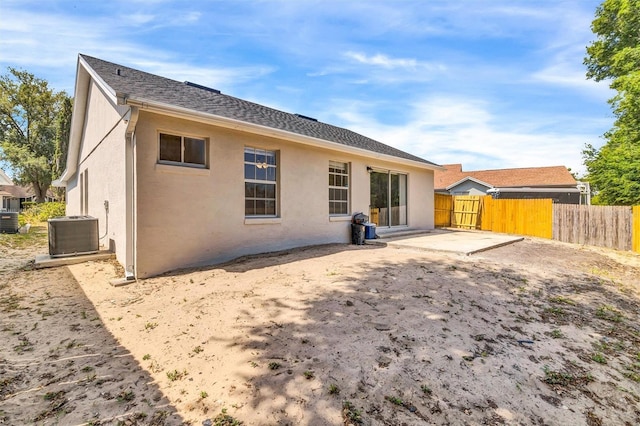 back of property featuring stucco siding, central AC, a patio, and fence