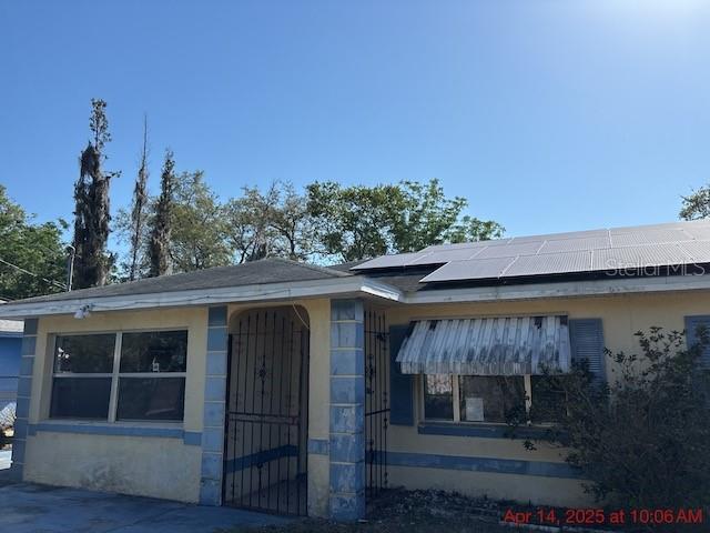 2117 Lemon St, Haines City, FL 33844 - view of front of home featuring roof mounted solar panels