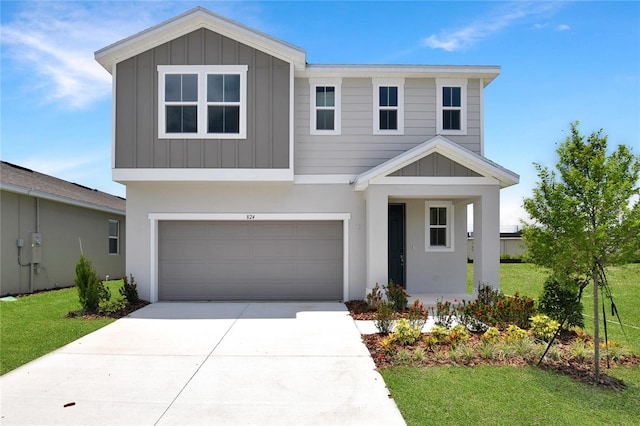 824 Lake Dell Rd, Dundee, FL 33838 - view of front of property featuring board and batten siding, an attached garage, concrete driveway, and a front lawn