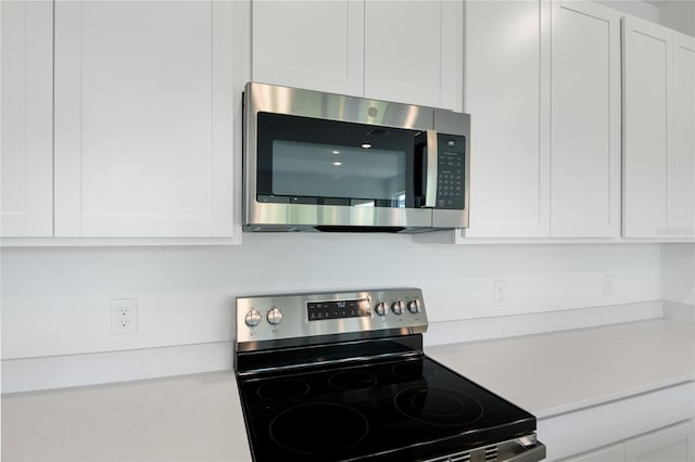 824 Lake Dell Rd, Dundee, FL 33838 - kitchen view of appliances with stainless steel finishes, light countertops, and white cabinetry