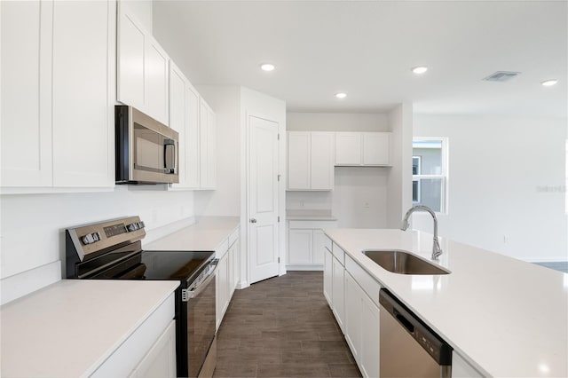 824 Lake Dell Rd, Dundee, FL 33838 - kitchen featuring appliances with stainless steel finishes, a sink, white cabinetry, recessed lighting, and light countertops