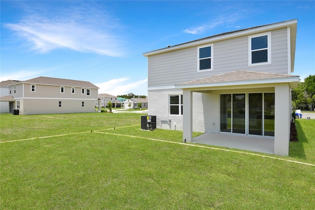 824 Lake Dell Rd, Dundee, FL 33838 - rear view of house featuring a yard, cooling unit, stucco siding, and roof with shingles